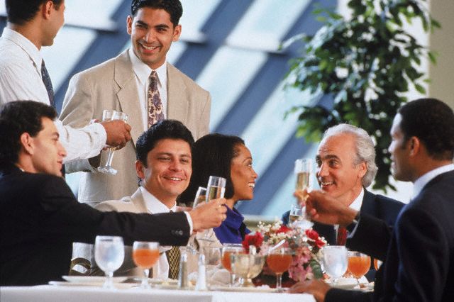Business executives toasting success at lunch